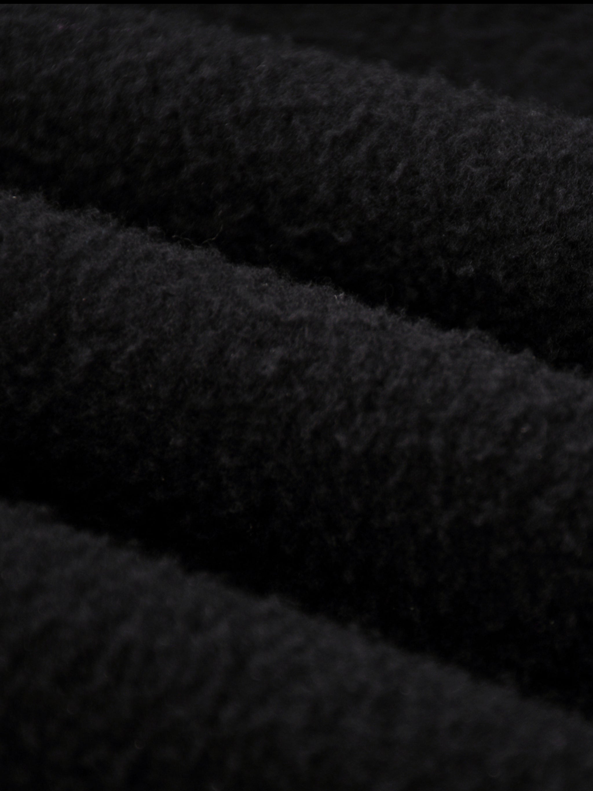 Close-up of thick black fleece fabric for Crossxnails Fleeced Jogger Pants, showcasing premium texture for comfort and warmth.