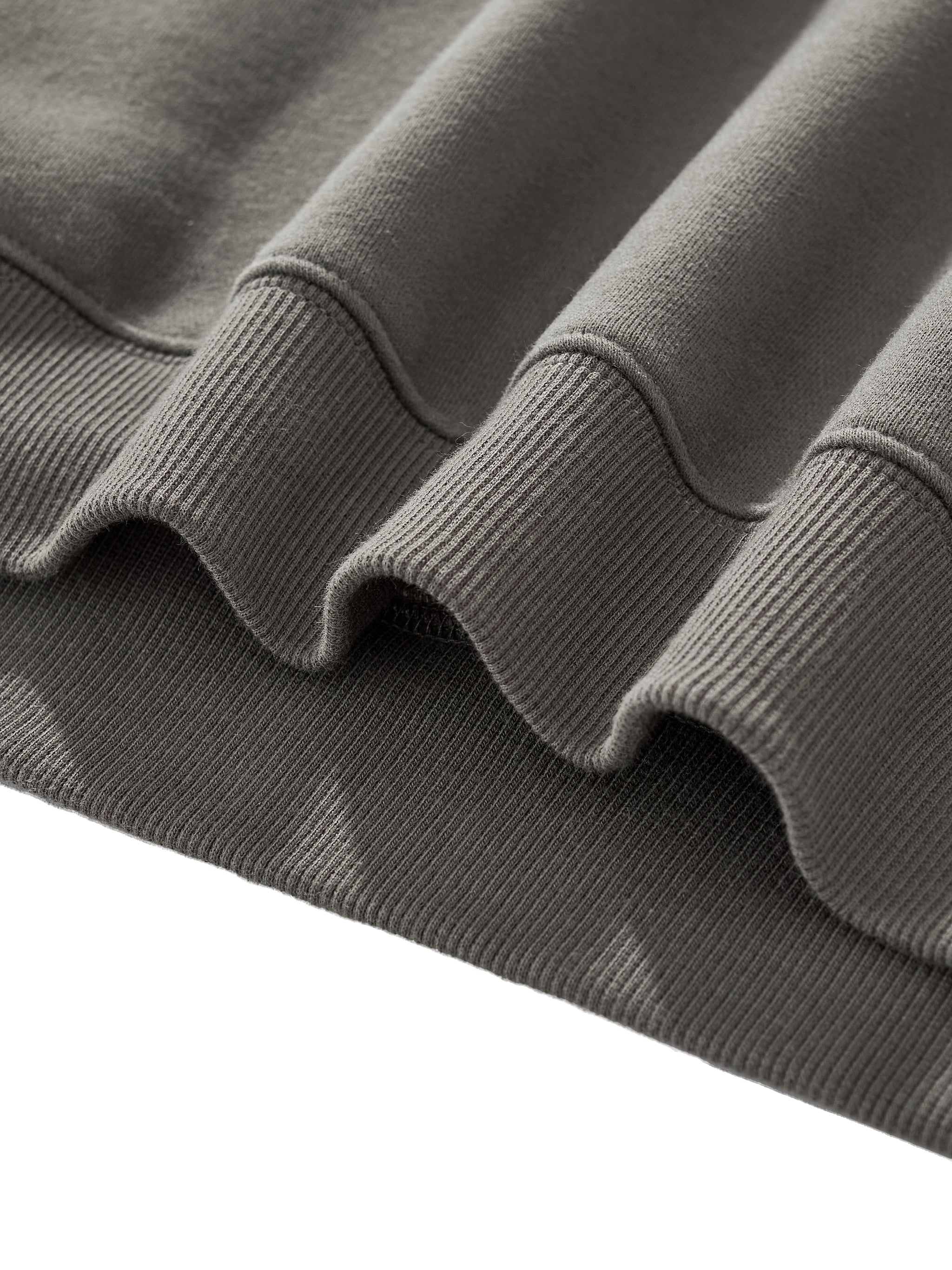 Close-up of the soft fleece hem detail of the Crossxnails Fleeced Boxy Hoodie, showcasing its premium fabric texture.