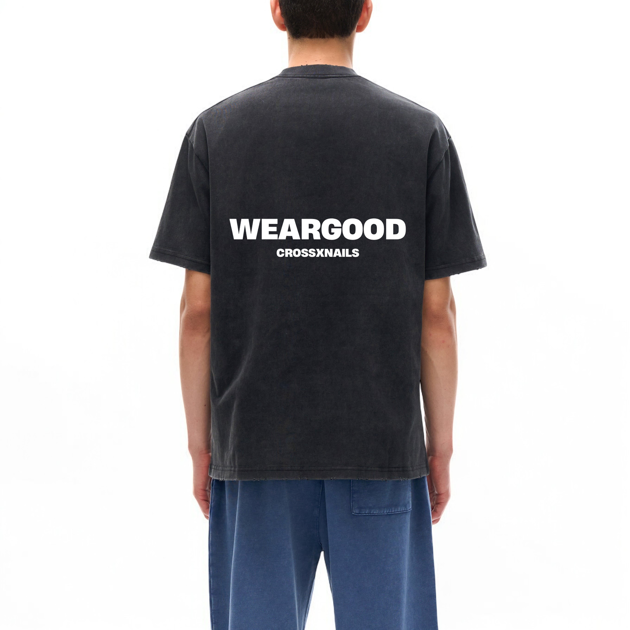 Back view of Crossxnails® Heavyweight Washed Oversized T-Shirt in black, featuring 'WEARGOOD' print, Christian streetwear fashion.