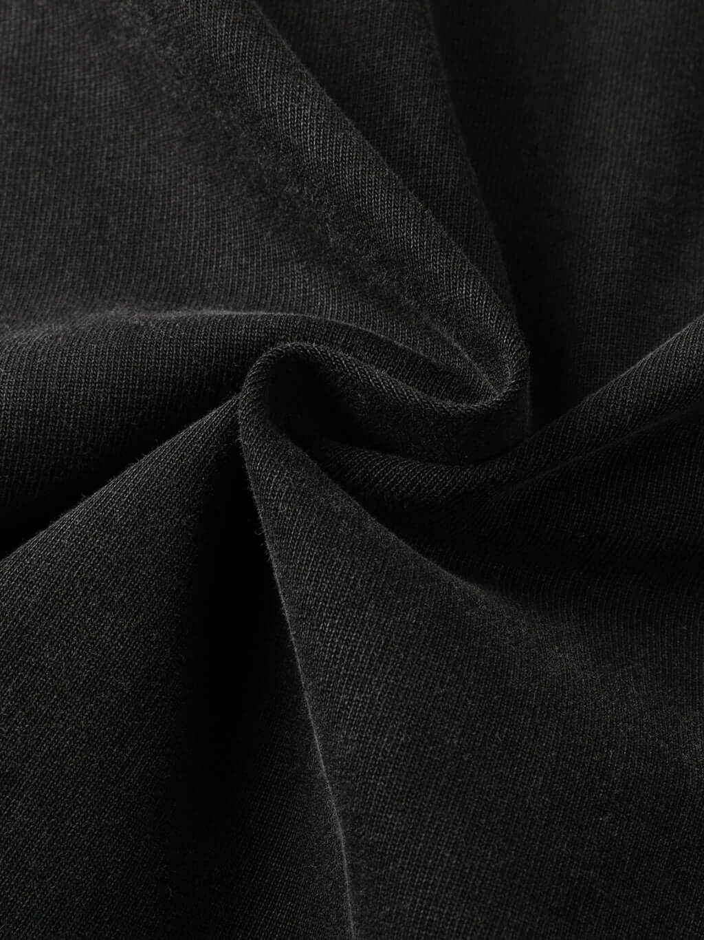 Close-up of black heavyweight fabric showcasing texture of Crossxnails oversized t-shirt, perfect for streetwear.