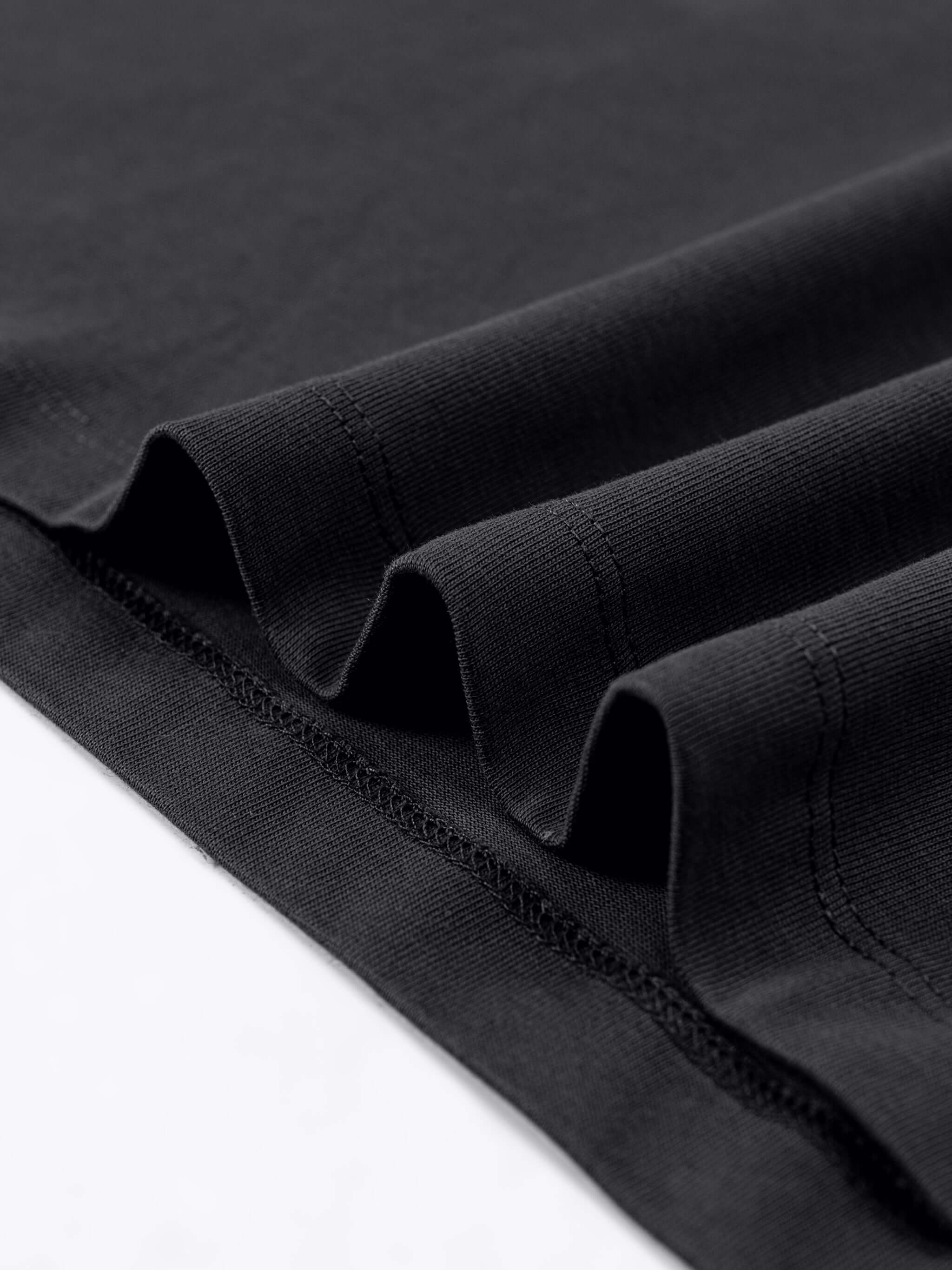 Close-up of the fabric layers of a Crossxnails Oversized T-Shirt in black, showcasing premium cotton texture and stitching details.