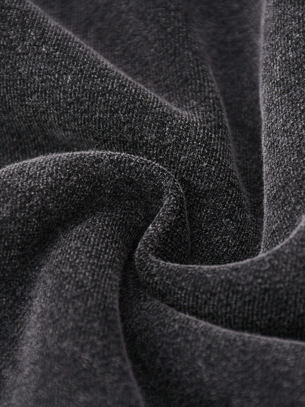 Close-up of soft, dark cotton-blend fleece fabric, perfect for oversized hoodies by Crossxnails, designed for comfort and style.