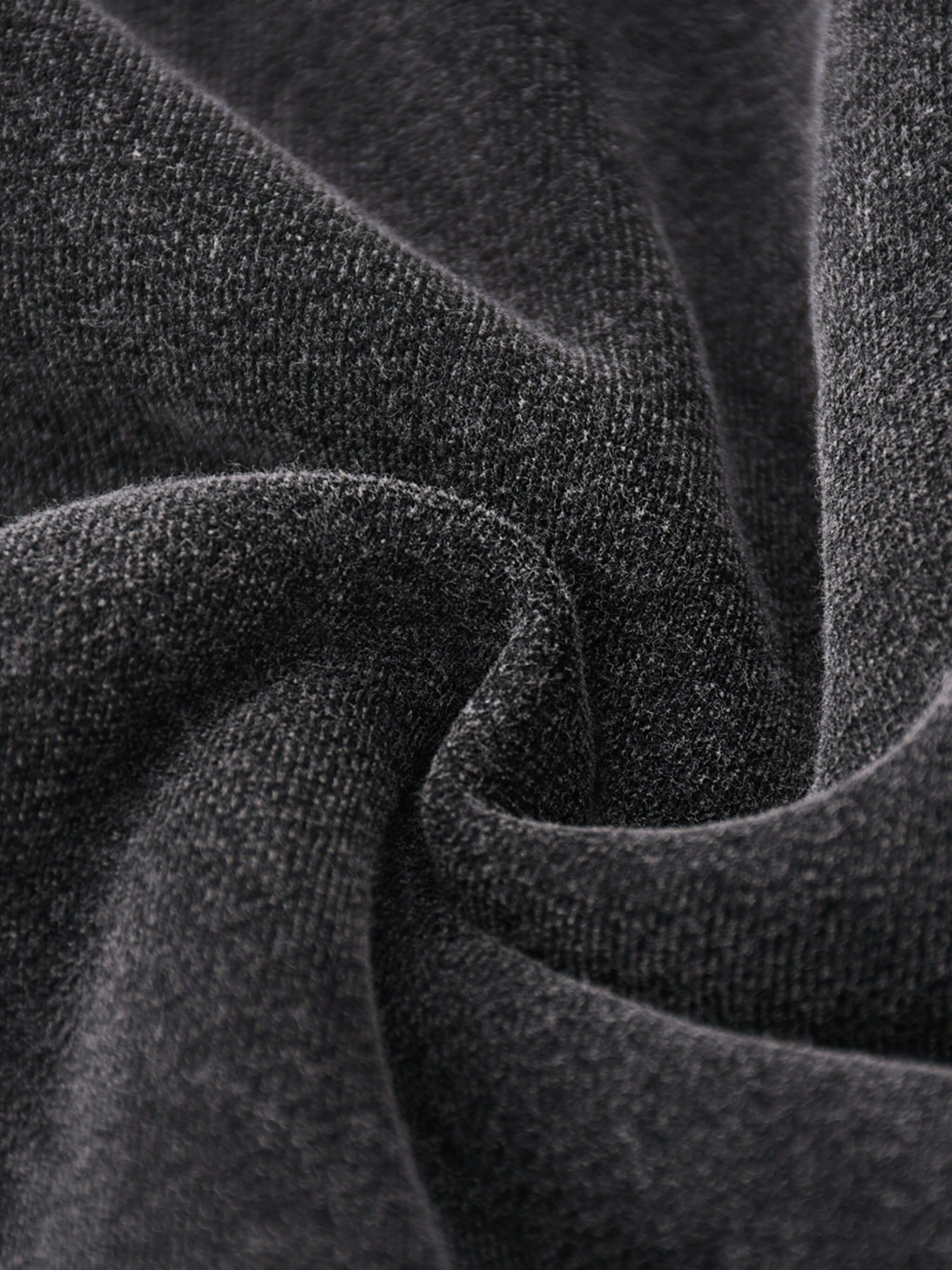 Close-up of soft, dark cotton-blend fleece fabric, perfect for oversized hoodies by Crossxnails, designed for comfort and style.