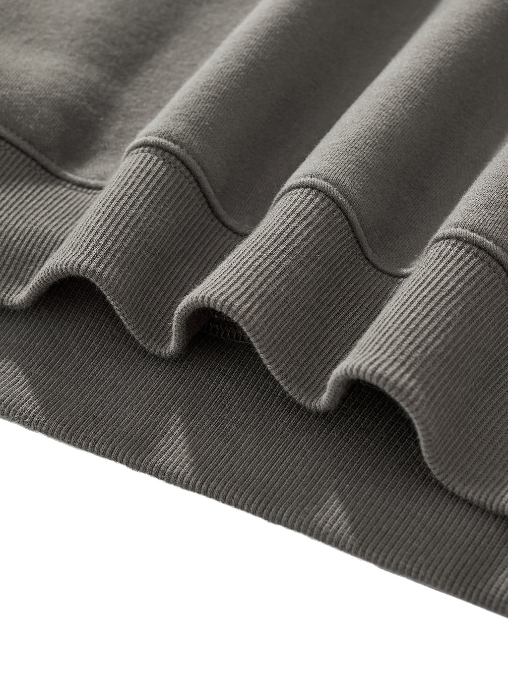Close-up of the soft fleece hem detail of the Crossxnails Fleeced Boxy Hoodie, showcasing its premium fabric texture.