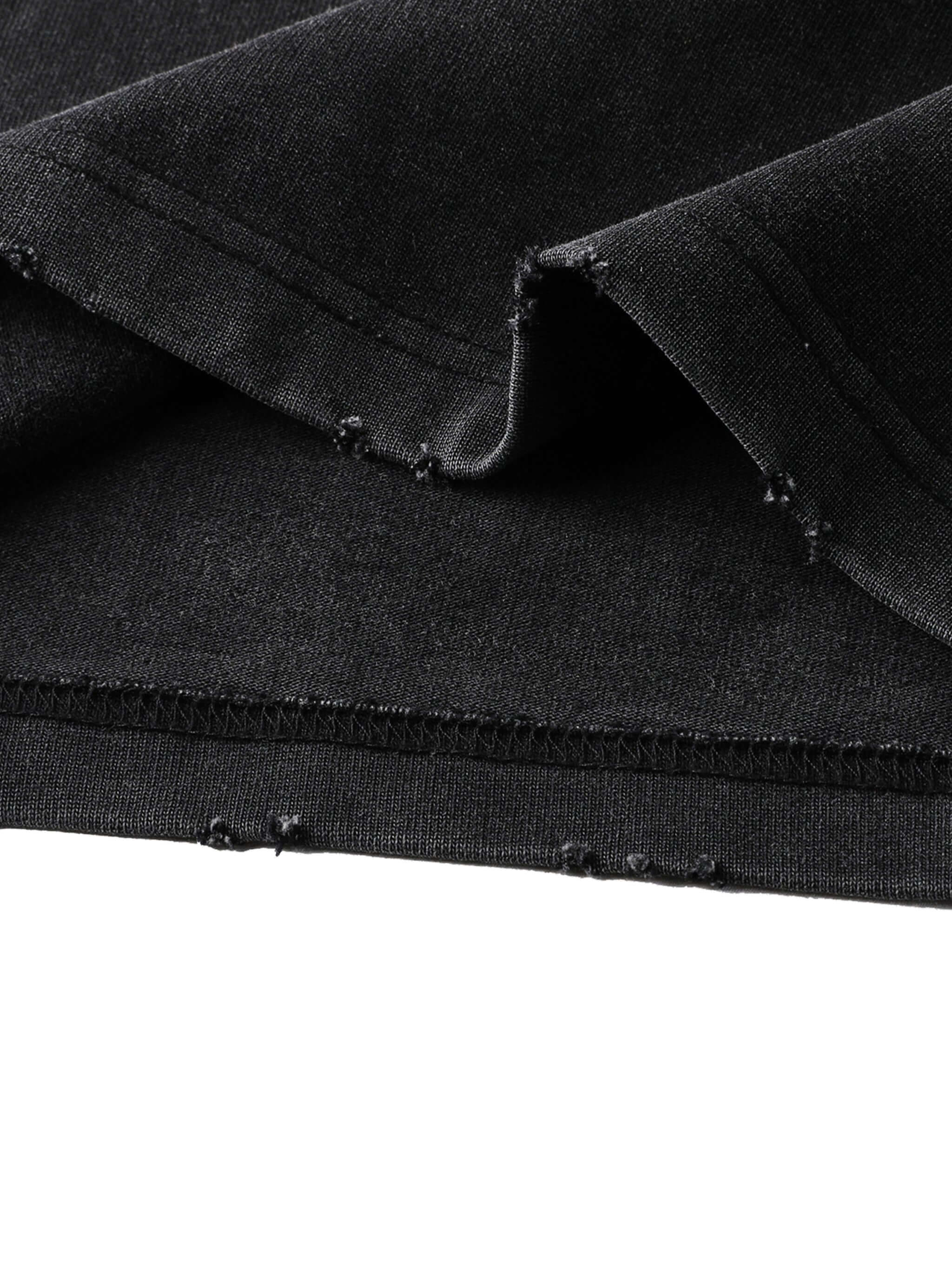 Close-up of Crossxnails® heavyweight washed oversized t-shirt fabric, showing premium stitching and quality in black.