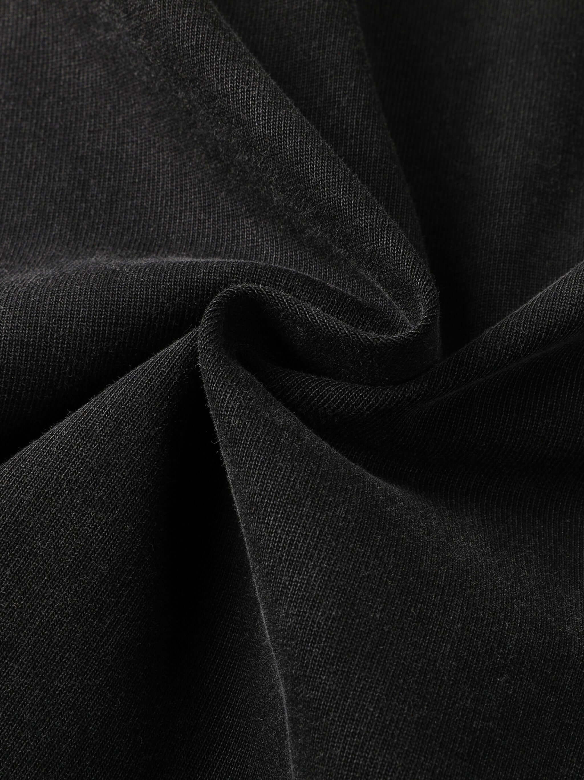 Close-up of premium 430gsm black cotton fabric showcasing texture for Crossxnails® oversized t-shirt, ideal for Christian streetwear.