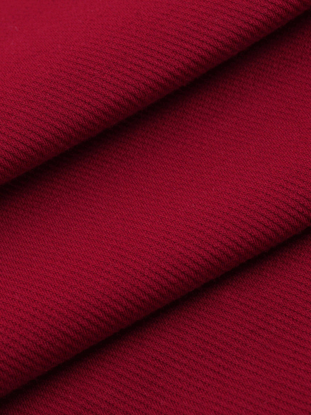 Close-up of soft, textured red fabric showcasing cotton blend ideal for Crossxnails WearGood button-up jersey.